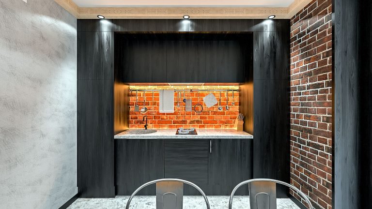 Дизайн однокомнатной квартиры в Гомеле, Гостиная - спальня в стиле лофт в квартире изображение 9, темная кухня, кирпич фартук кухни с подсветкой теплого освещения, компактный кухонный гарнитур в стиле лофт, балки с подсветкой